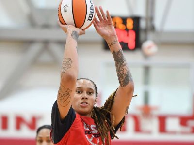 Brittney Griner is shooting a ball toward the hoop in the picture.